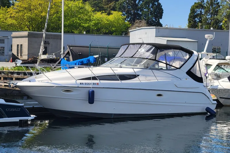 Slide: The Image of 1999 Bayliner 3055 Ciera Sunbridge boat docked at marina, sunny day. - 7