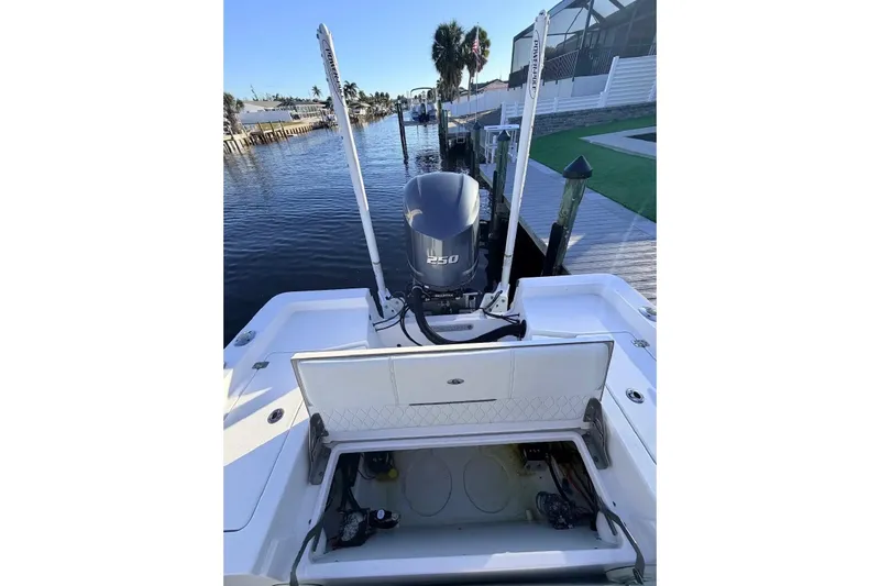 Slide: The Image of 2020 Sportsman Masters 247 Bay Boat with open storage, docked by waterfront. - 2