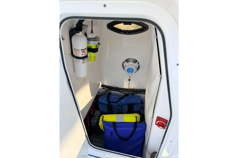 Slide: The Image of Interior of 2020 Sportsman Masters 247 Bay Boat with storage and safety equipment. - 5