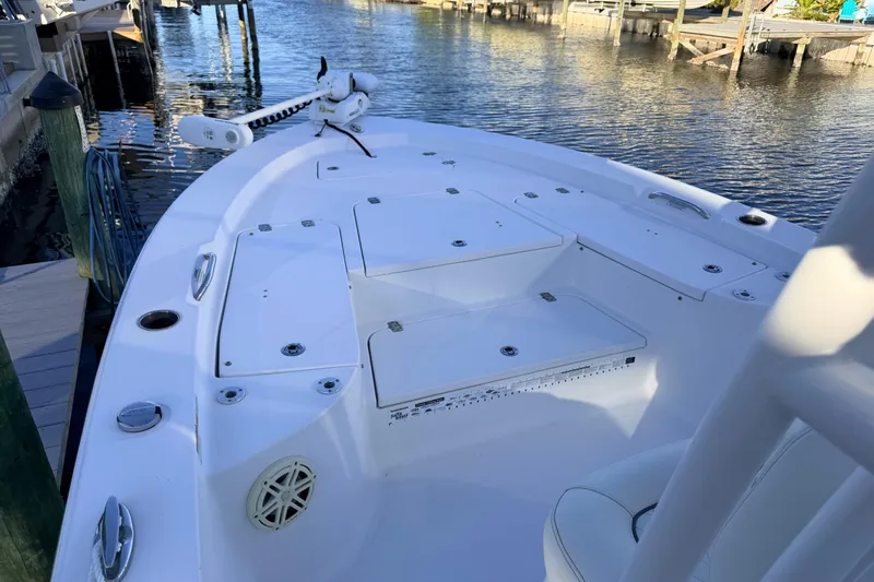 Slide: The Image of 2020 Sportsman Masters 247 Bay Boat docked, showcasing spacious deck and storage compartments. - 6