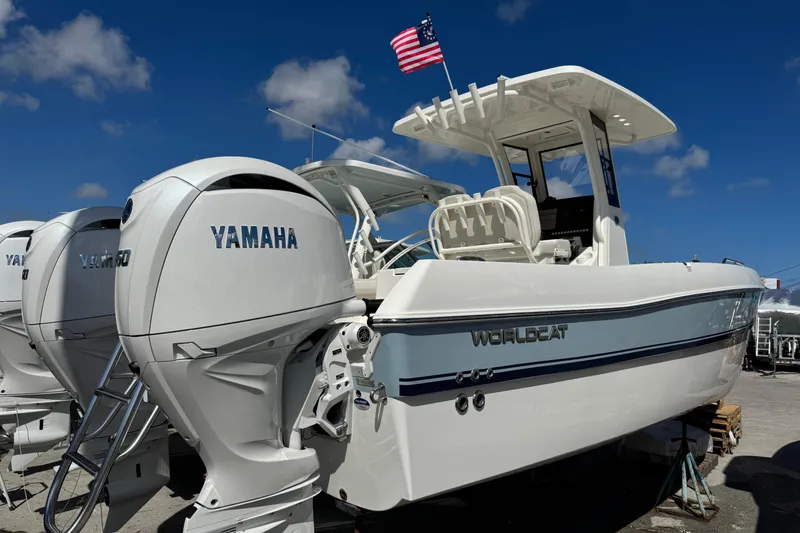 Slide: The Image of 2026 World Cat 235 TE boat with Yamaha engines, docked under a clear blue sky. - 1