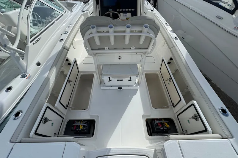 Slide: The Image of 2026 World Cat 235 TE boat interior with open storage compartments and seating. - 11