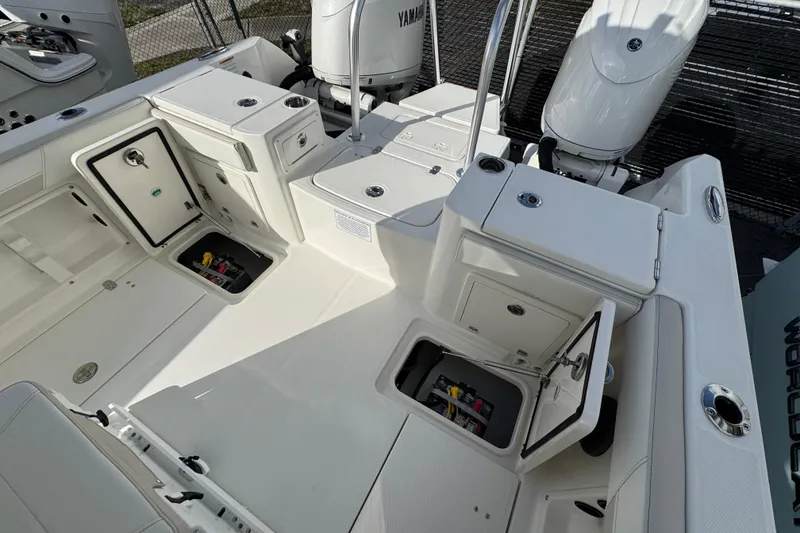 Slide: The Image of 2026 World Cat 235 TE boat interior with storage compartments and Yamaha engines. - 12