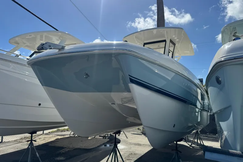 Slide: The Image of 2026 World Cat 235 TE boat displayed outdoors under a clear blue sky. - 2