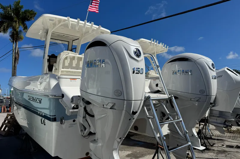Slide: The Image of 2026 World Cat 235 TE boat with twin Yamaha 150 engines, docked under clear blue sky. - 4