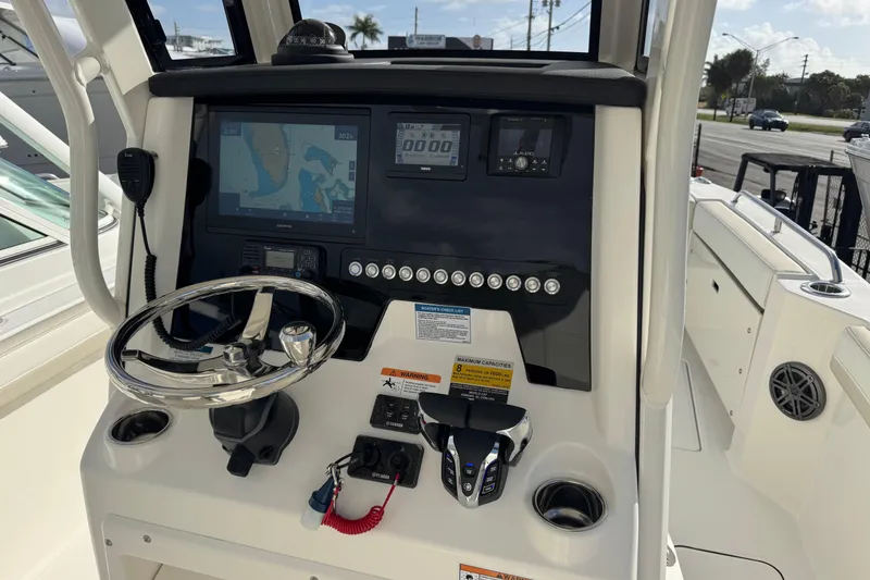 Slide: The Image of Helm of 2026 World Cat 235 TE boat with navigation and control systems. - 5