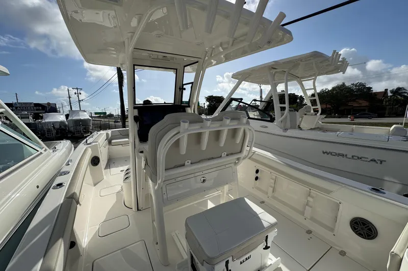 Slide: The Image of 2026 World Cat 235 TE boat interior with seating and console, under a clear sky. - 8