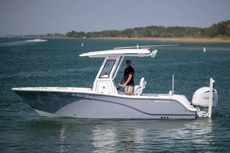 The Image of 2025 Sea Fox 228 Commander boat cruising on a calm lake with a person at the helm. - 1