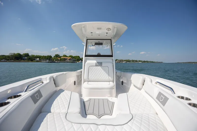 Slide: The Image of 2025 Sea Fox 228 Commander boat interior with white seating on a sunny day. - 12