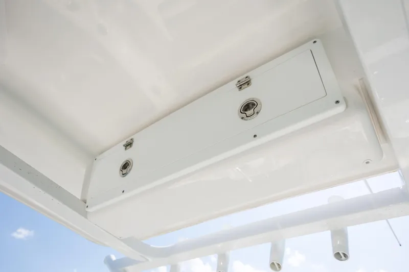Slide: The Image of 2025 Sea Fox 228 Commander boat storage compartment with secure latches, viewed from below. - 14