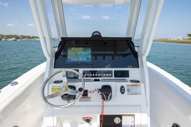 Slide: The Image of 2025 Sea Fox 228 Commander boat dashboard with navigation system on open water. - 18
