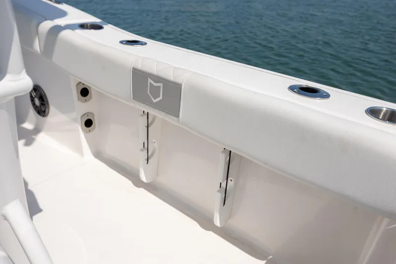 Slide: The Image of 2025 Sea Fox 228 Commander boat interior detail with rod holders and ocean view. - 19