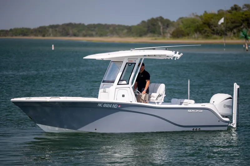 Slide: The Image of 2025 Sea Fox 228 Commander boat on calm water, side view. - 2