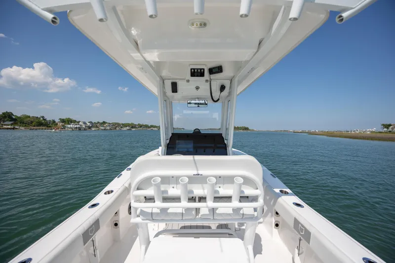 Slide: The Image of 2025 Sea Fox 228 Commander boat on calm water, showcasing helm and seating area. - 21