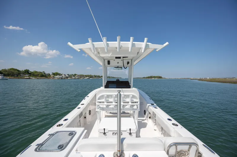 Slide: The Image of 2025 Sea Fox 228 Commander boat on calm water under clear blue sky. - 22