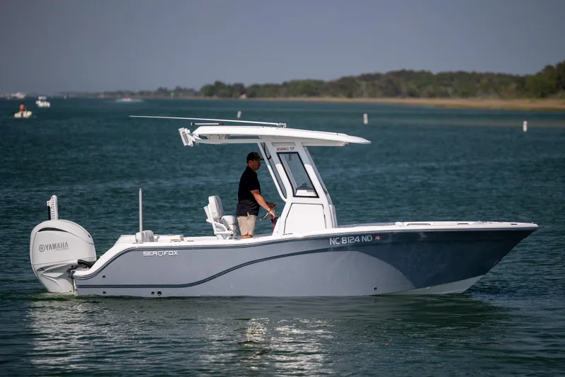 Slide: The Image of 2025 Sea Fox 228 Commander boat cruising on a calm lake with a Yamaha engine. - 5