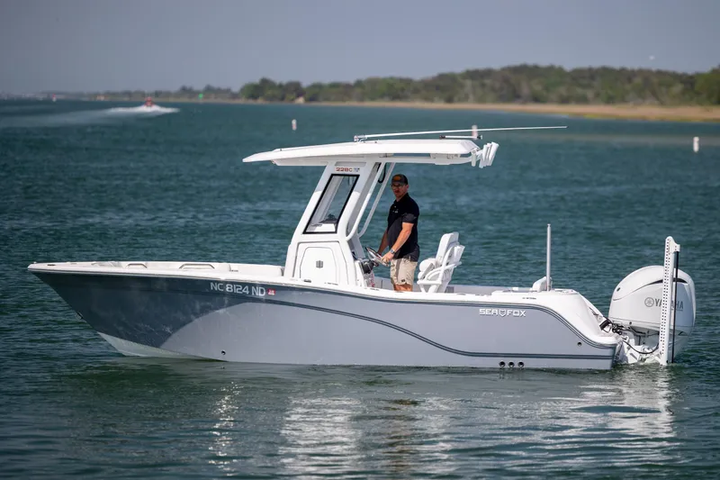 Slide: The Image of 2025 Sea Fox 228 Commander boat cruising on a calm lake with a Yamaha engine. - 9