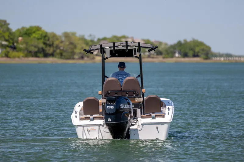 Slide: The Image of 2025 Sea Pro 202 Center Console boat cruising on a serene lake with lush greenery. - 10