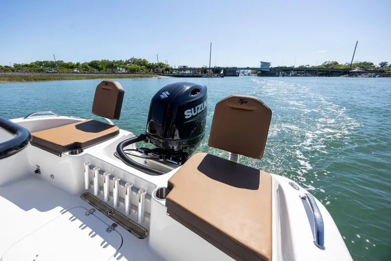 Slide: The Image of 2025 Sea Pro 202 Center Console boat with Suzuki engine on a sunny day. - 12
