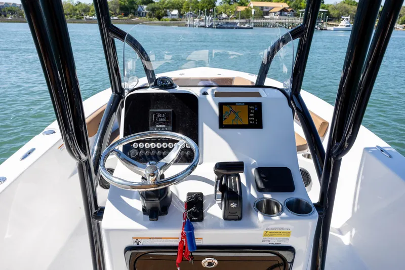 Slide: The Image of 2025 Sea Pro 202 Center Console boat dashboard with steering wheel and navigation display. - 15