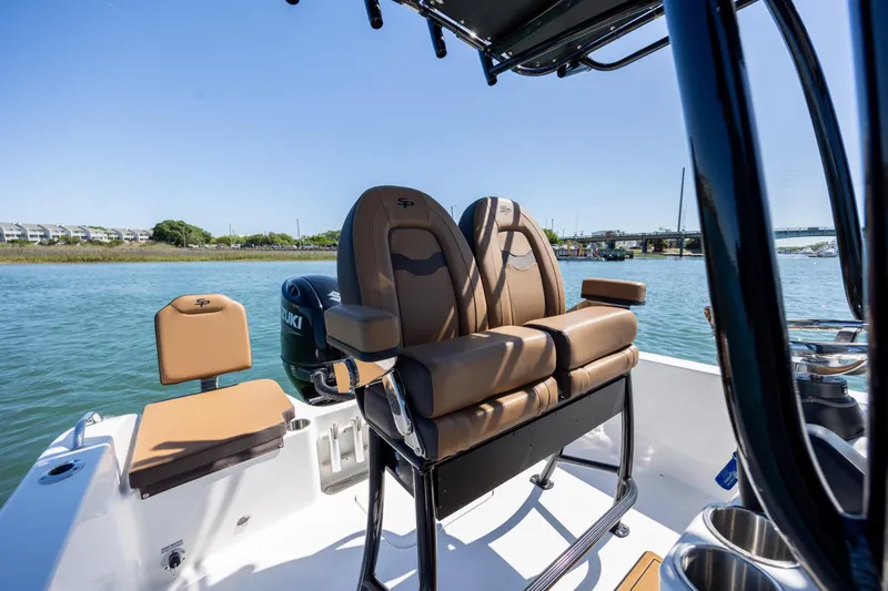 Slide: The Image of 2025 Sea Pro 202 Center Console boat interior with brown seating on a sunny day. - 17