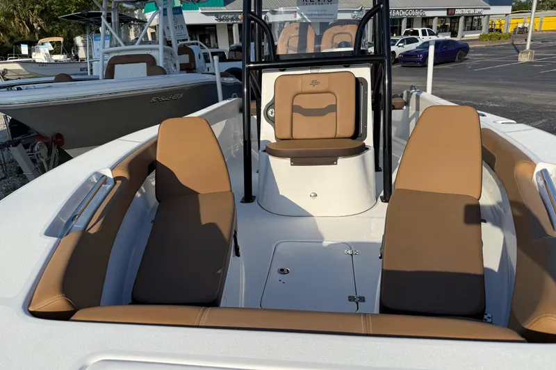 Slide: The Image of 2025 Sea Pro 202 Center Console boat with tan seating in a parking lot. - 22