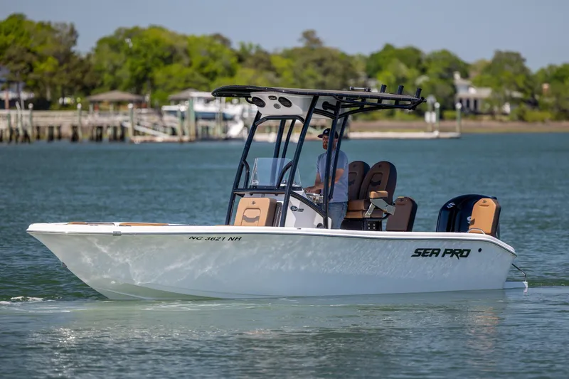 Slide: The Image of 2025 Sea Pro 202 Center Console boat cruising on a calm lake with scenic background. - 6