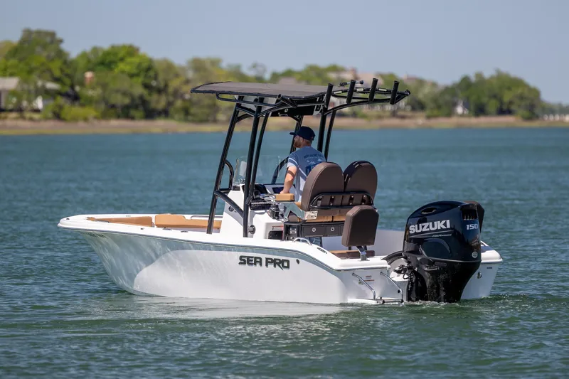 Slide: The Image of 2025 Sea Pro 202 Center Console boat cruising on a calm lake with Suzuki engine. - 9