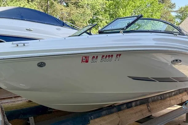 The Image of 2014 Sea Ray 190 Sport boat on trailer, side view with registration number visible. - 0