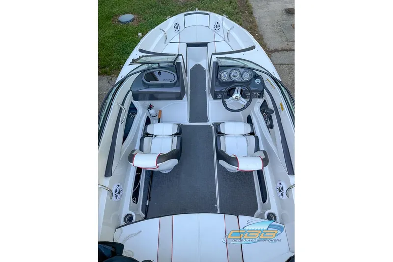 Slide: The Image of 2014 Sea Ray 190 Sport boat interior with white seating and dashboard view. - 1