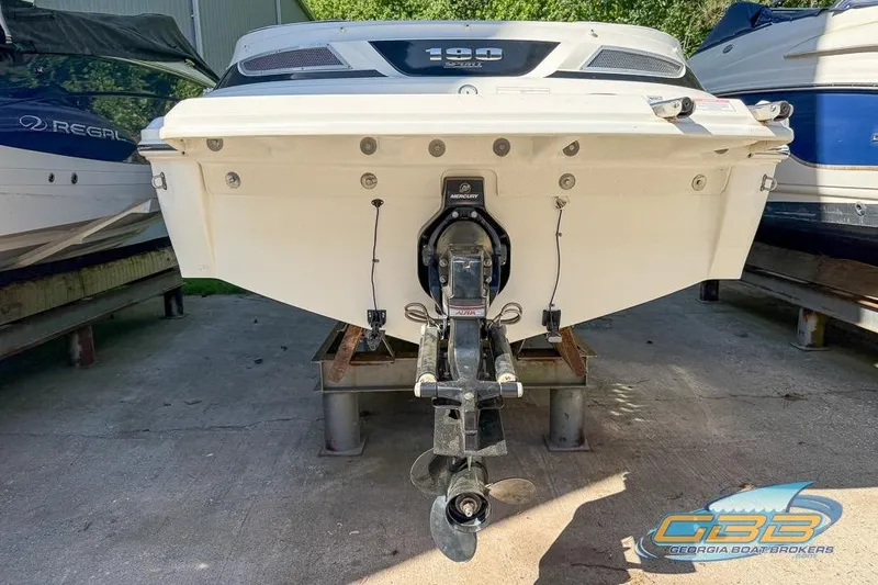 Slide: The Image of 2014 Sea Ray 190 Sport boat rear view with Mercury outboard motor. - 12
