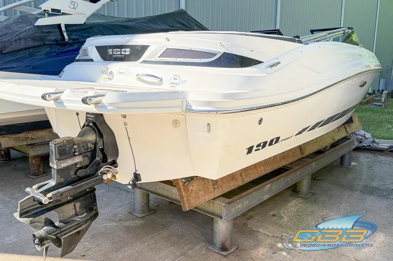 Slide: The Image of 2014 Sea Ray 190 Sport boat on display with MerCruiser engine. - 13