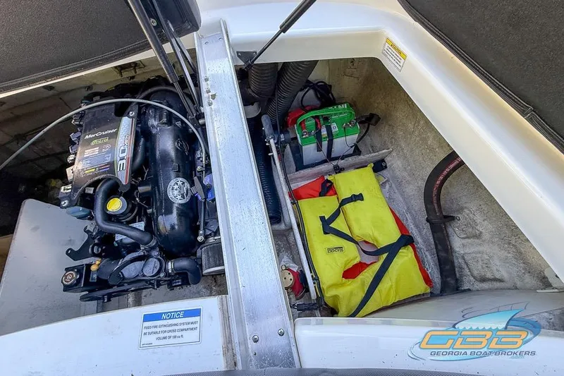 Slide: The Image of Engine compartment of a 2014 Sea Ray 190 Sport with safety equipment and battery. - 15
