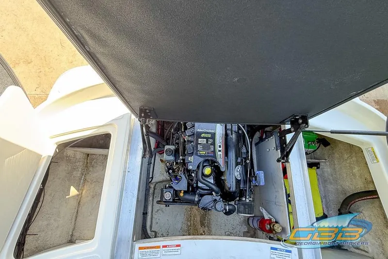 Slide: The Image of Engine compartment of a 2014 Sea Ray 190 Sport boat, featuring a MerCruiser engine. - 16