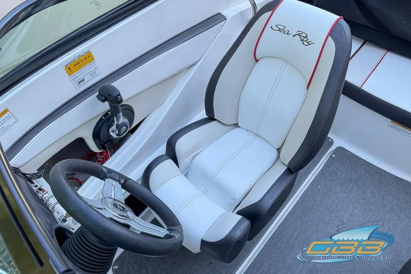 Slide: The Image of 2014 Sea Ray 190 Sport boat interior with steering wheel and branded seat. - 18