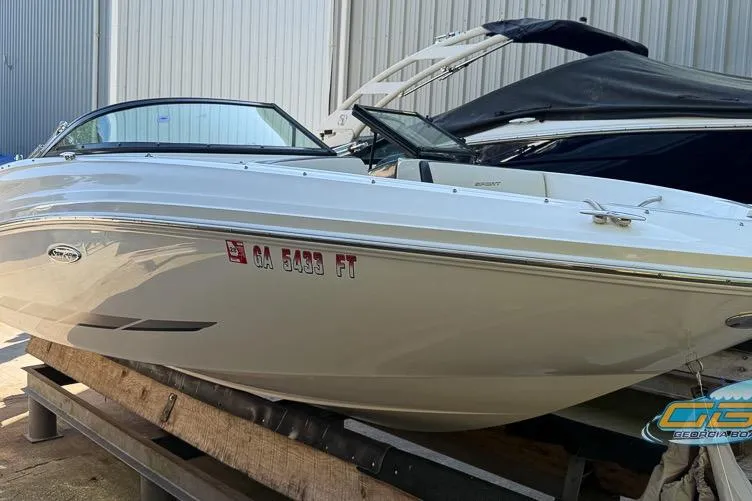 Slide: The Image of 2014 Sea Ray 190 Sport boat in storage, white exterior, side view. - 2