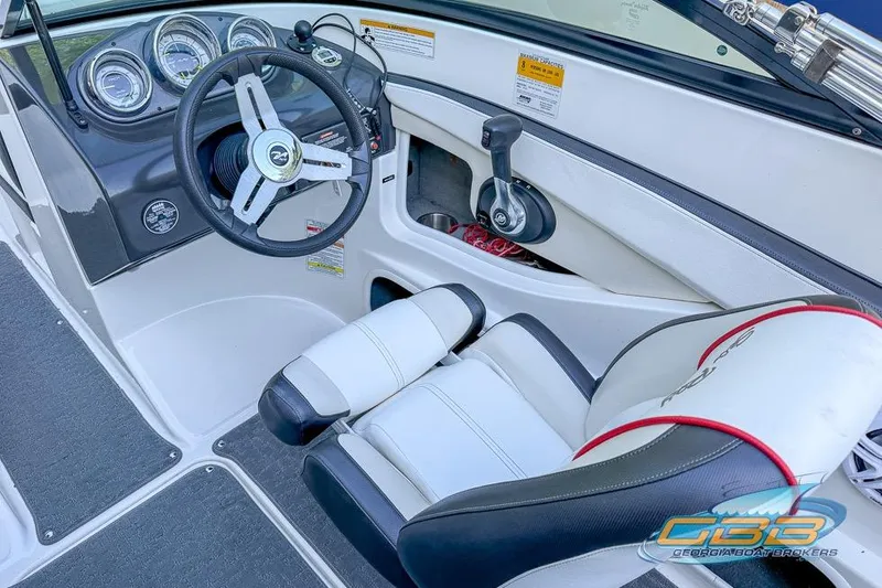 Slide: The Image of 2014 Sea Ray 190 Sport boat interior with steering wheel and dashboard controls. - 4