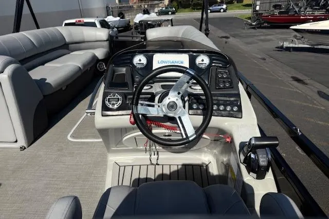 Slide: The Image of 2018 Regency 254 LE3 boat dashboard with steering wheel and control panel. - 10