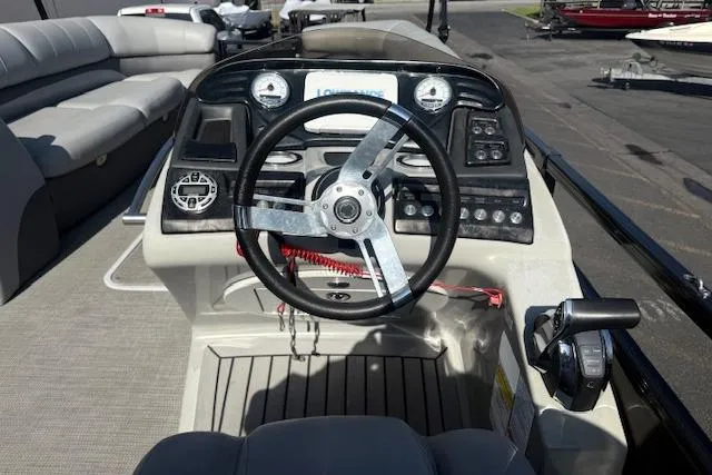 Slide: The Image of Cockpit of 2018 Regency 254 LE3 boat with steering wheel and control panel. - 12