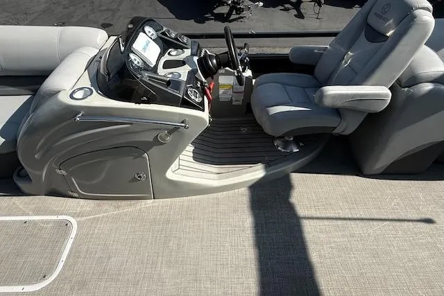 Slide: The Image of 2018 Regency 254 LE3 boat interior with steering console and captain's chair. - 13
