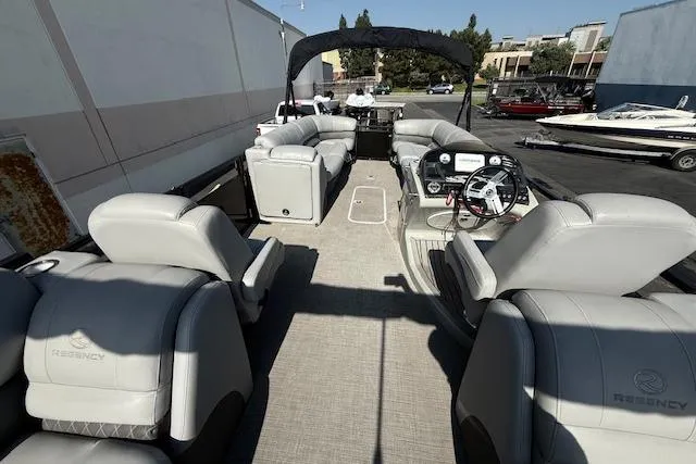 Slide: The Image of 2018 Regency 254 LE3 pontoon boat with spacious seating and modern helm. - 16