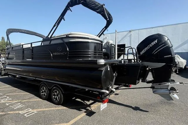 Slide: The Image of 2018 Regency 254 LE3 pontoon boat with Mercury outboard motor on trailer. - 3