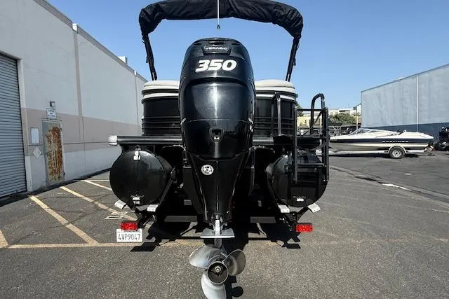 Slide: The Image of 2018 Regency 254 LE3 boat with powerful 350 engine, parked in an industrial area. - 5