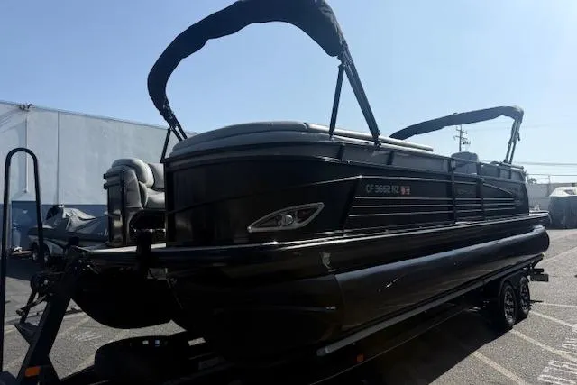 Slide: The Image of 2018 Regency 254 LE3 pontoon boat on trailer, parked outdoors. - 7