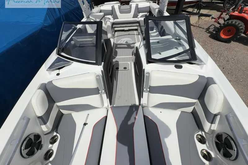 Slide: The Image of 2019 Malibu Wakesetter 24 MXZ interior with open windshield and seating area. - 10