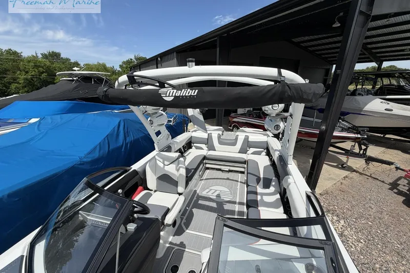 Slide: The Image of 2019 Malibu Wakesetter 24 MXZ boat interior with seating and wakeboard tower. - 12