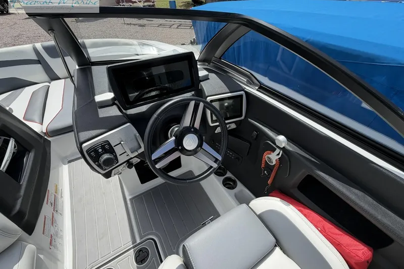 Slide: The Image of 2019 Malibu Wakesetter 24 MXZ boat interior with modern dashboard and steering wheel. - 18