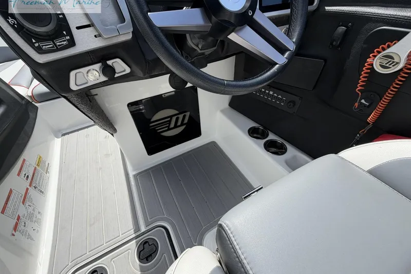 Slide: The Image of 2019 Malibu Wakesetter 24 MXZ boat cockpit with steering wheel and control panel. - 19