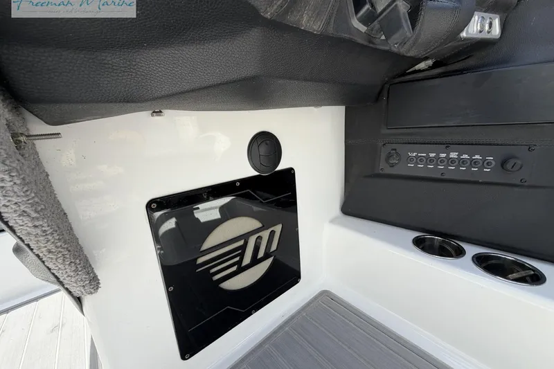 Slide: The Image of 2019 Malibu Wakesetter 24 MXZ dashboard with control panel and logo. - 22