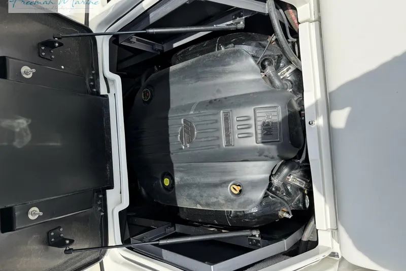 Slide: The Image of Engine compartment of a 2019 Malibu Wakesetter 24 MXZ boat, showcasing the engine details. - 23